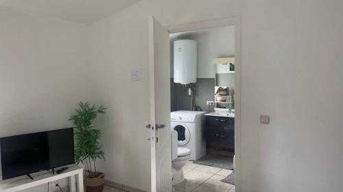 a white bathroom with a toilet and a sink at Appartement chic bien situé in Mons