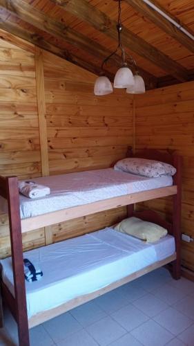 a bedroom with two bunk beds in a cabin at Cabaña El Refugio in La Carrera