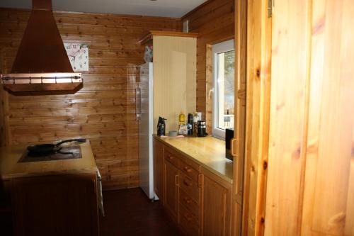 a kitchen with wooden walls and a counter top at Senja Aurora in Senja