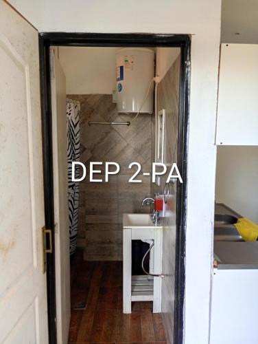 a door into a small kitchen with a sink at Alquituc Escobar in Belén de Escobar