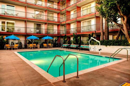 a swimming pool in front of a hotel at Fairfield Inn & Suites by Marriott Los Angeles LAX/El Segundo in El Segundo