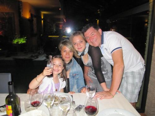 a family posing for a picture at a table with wine glasses at CASA ROMAN ITALIA, Center Sacile in Sacile
