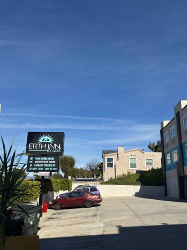 a car parked in a parking lot with a sign at Vista Motel in Los Angeles
