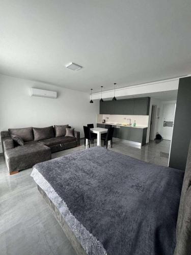 a living room with a couch and a table at CoyrtYard Longbeach Bölgesi İskele Mersin via 10 Cyprus 99850 TRNC Iskele in Iskele