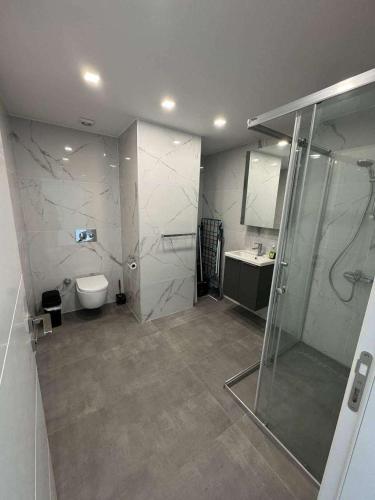a bathroom with a shower and a toilet and a sink at CoyrtYard Longbeach Bölgesi İskele Mersin via 10 Cyprus 99850 TRNC Iskele in Iskele