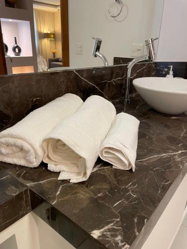 two towels are sitting on a counter in a bathroom at Sequoia - Alphaville in Barueri
