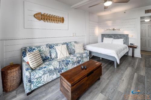 a living room with a couch and a bed at Pirates Bay A108 in Fort Walton Beach