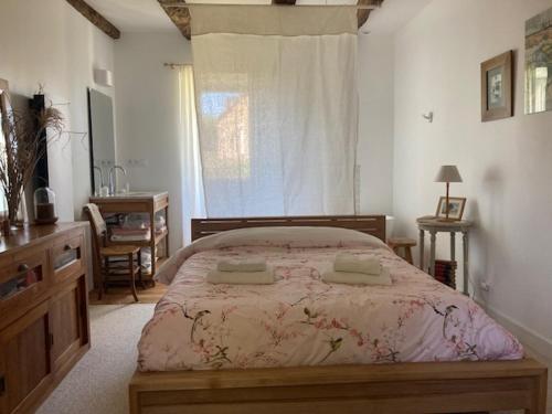 a bedroom with a bed and a desk and a window at Ker Gwezenn in Tramain