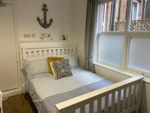 a small bed in a small room with a window at Harbour House Holiday Apartments in Bridlington