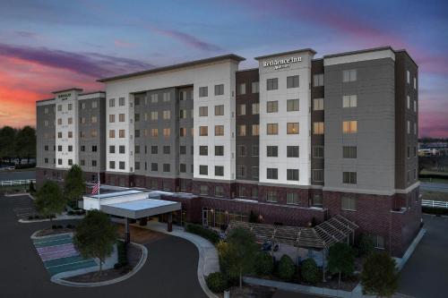 a rendering of a hotel building with a sunset in the background at Residence Inn by Marriott Charlotte Northlake in Charlotte