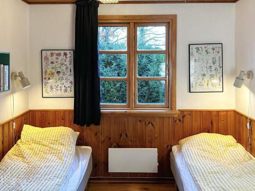 a bedroom with two beds and a window at 4 person holiday home in Aars-By Traum in Års