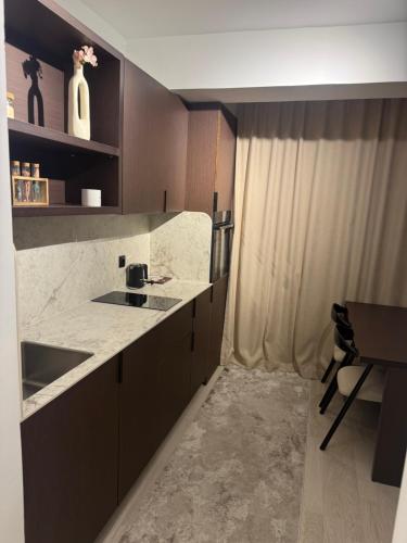 a kitchen with a sink and a counter top at Deluxe Apartment 1 in Gnjilane