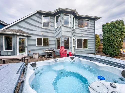 a house with a swimming pool in front of a house at Sand On My Toes in Seaside