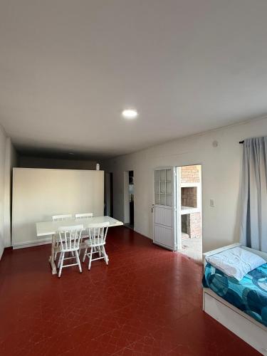 a room with a table and two chairs and a bed at Bruma in Leones
