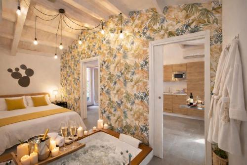 a bedroom with a bed and a wall with a floral wallpaper at SicilyNice in Avola