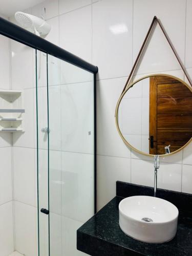 a bathroom with a sink and a mirror at Bigorú Flats in Itacaré