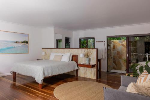 a bedroom with a bed and a large window at Away Guesthouse- Away on Shirley Lane in Byron Bay