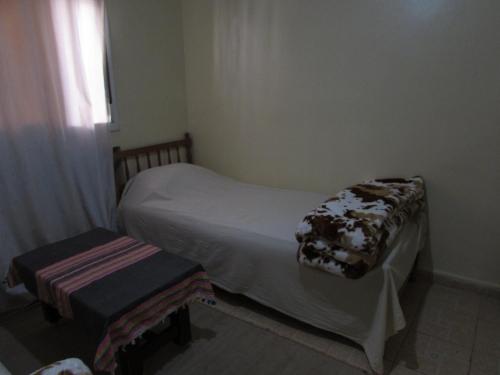 a small bedroom with a bed and a window at Bed and breakfast in Ifrane