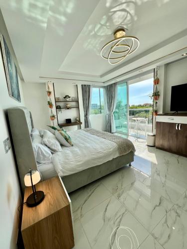 a bedroom with a king sized bed and a television at Ritacuba House Boutique in Santa Marta