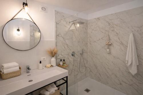 a bathroom with a shower and a sink and a mirror at SicilyNice in Avola
