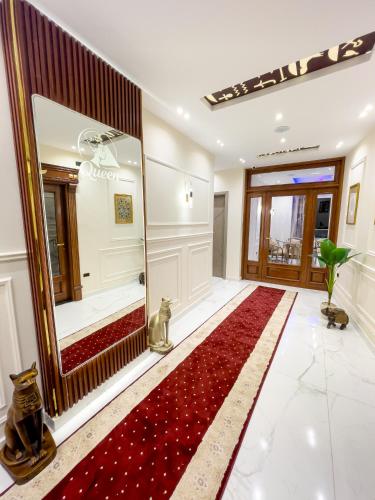 a living room with a red rug and a mirror at Queen Inn Pyramids View in Cairo