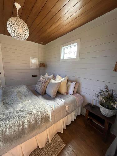 a bedroom with a bed with pillows and a window at Mountain Range Guesthouse in Dovedale