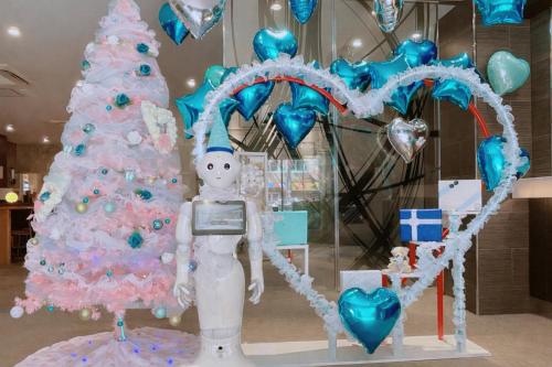 a christmas display with a snow man next to a christmas tree at Hotel Sunplaza 2 Annex in Osaka