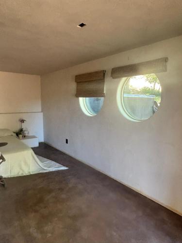 a bedroom with two windows and a bed at Kit Inn Wetrock in Moab