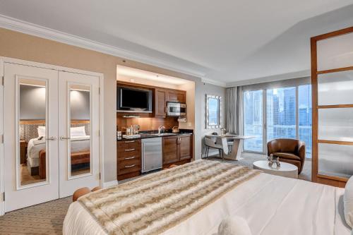 a hotel room with a large bed and a bathroom at MGM Signature Luxury Jr Suite with Balcony Strip and Sphere Views in Las Vegas