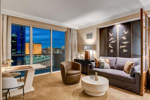 a living room with a couch and a large window at MGM Signature Luxury Jr Suite with Balcony Strip and Sphere Views in Las Vegas