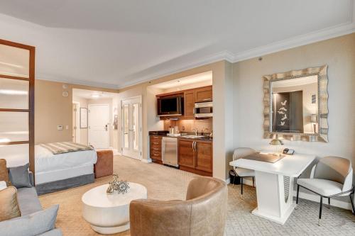 a hotel room with a bed and a living room at MGM Signature Luxury Jr Suite with Balcony Strip and Sphere Views in Las Vegas
