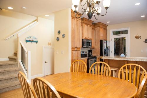 a kitchen and dining room with a wooden table and chairs at Sea Quest in Lincoln City