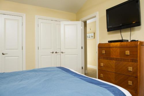 a bedroom with a bed and a television on a dresser at Sea Quest in Lincoln City