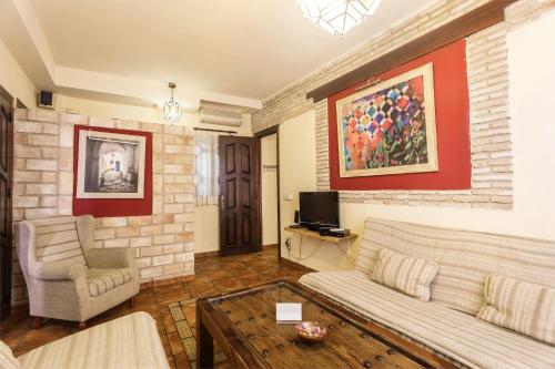 a living room with a couch and a tv at Arte Vida Suites & Spa in Granada