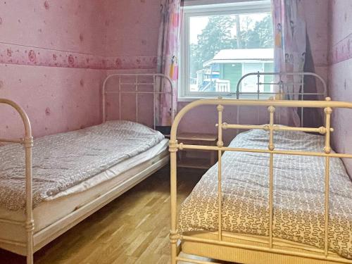 two beds in a room with a window at 8 person holiday home in Mönsterås in Mönsterås
