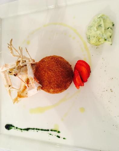a white plate with a sandwich and strawberries on it at Hotel Garden Bocca di Magra in Bocca di Magra