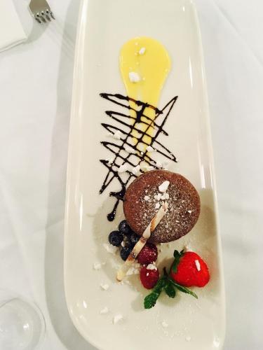 a plate of food with dessert on a table at Hotel Garden Bocca di Magra in Bocca di Magra