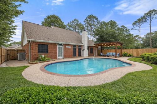 a swimming pool in the yard of a house at Amazing Bay Villa Near NASA with Pool & Pool Table in Houston