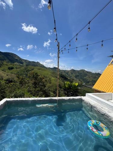a swimming pool with a view of the mountains at Casa Mostaza-Ecolodge in Samaná