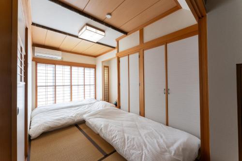 a bedroom with a bed and a window at 野町 庵 in Kanazawa