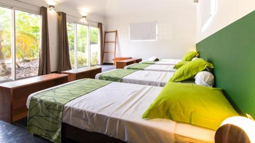 En eller flere senge i et værelse på Villa La Ressource