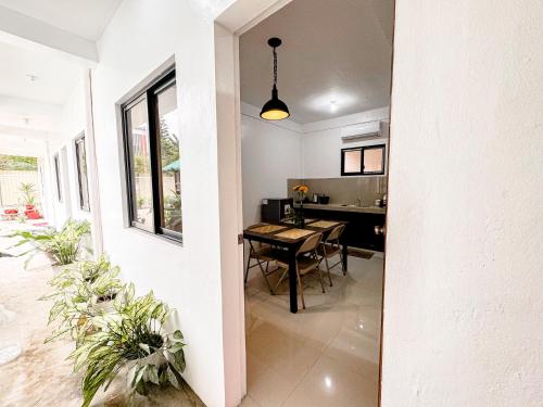 a kitchen and dining room with a table in a house at LAD Private Reosrt in Dasmariñas