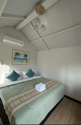 a bedroom with a large bed with blue pillows at Lanta Junli House in Ko Kam Yai