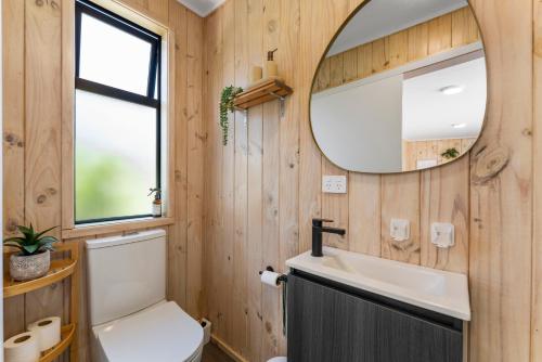 a bathroom with a sink and a mirror at Thomson's Nook - Taupo in Taupo