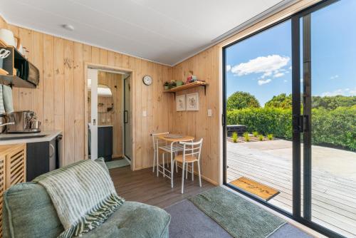 a kitchen and living room with a view of a deck at Thomson's Nook - Taupo in Taupo