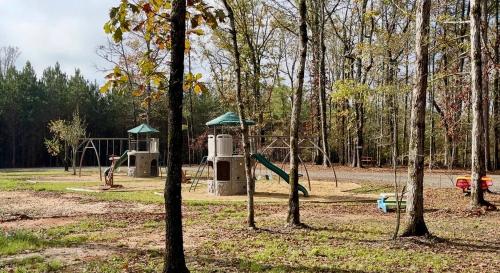 a park with a playground with a swing set at Huckleberry Hideaway in Minden
