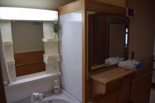 a bathroom with a sink and a mirror at やぎみちの家 yagimichi-noie in Sasebo