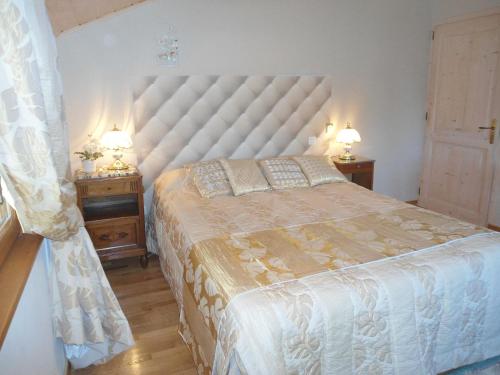 a bedroom with a large bed and two night stands at Domaine des Charmilles in Mantenay-Montlin