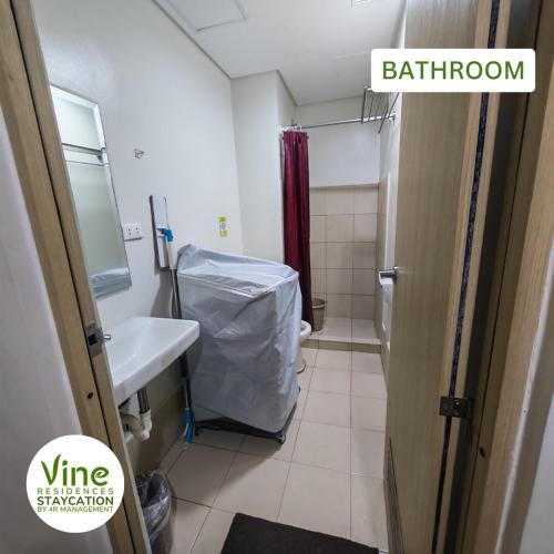 a small bathroom with a sink and a toilet at Vine Residences Staycation in Manila