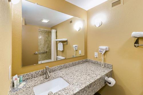 a bathroom with a sink and a mirror at Quality Inn & Suites Lubbock South in Lubbock